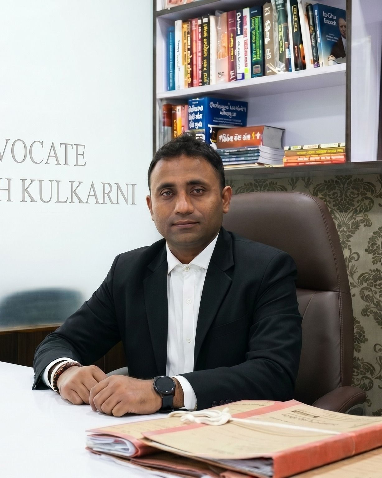 Advocate Bhavesh Kulkarni at his desk in the Rander Road office, Surat